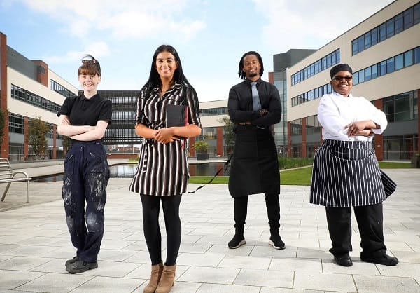 Four students in different outfits representing further education